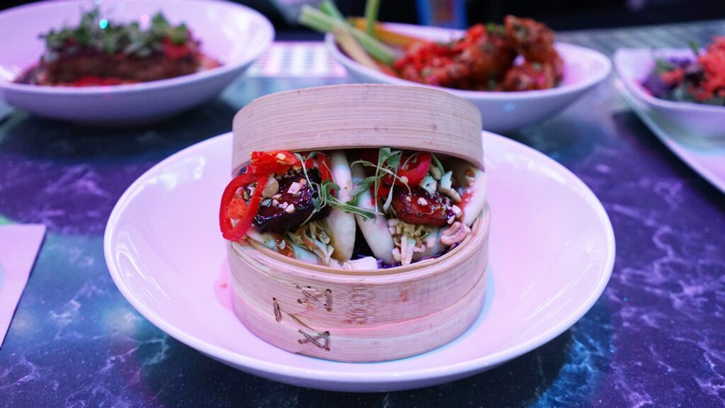 Assorted dishes including bao buns presented on a table