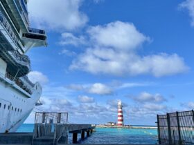 cruise ship and Caribbean waters with lighthouse in the background