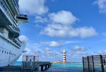 cruise ship and Caribbean waters with lighthouse in the background