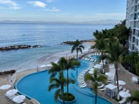 Pool, hotel, and Bay of Banderas view at Hilton Vallarta Riviera all-inclusive resort