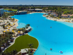 Sprawling lagoon surrounded by grassy lawns, small beaches and buildings