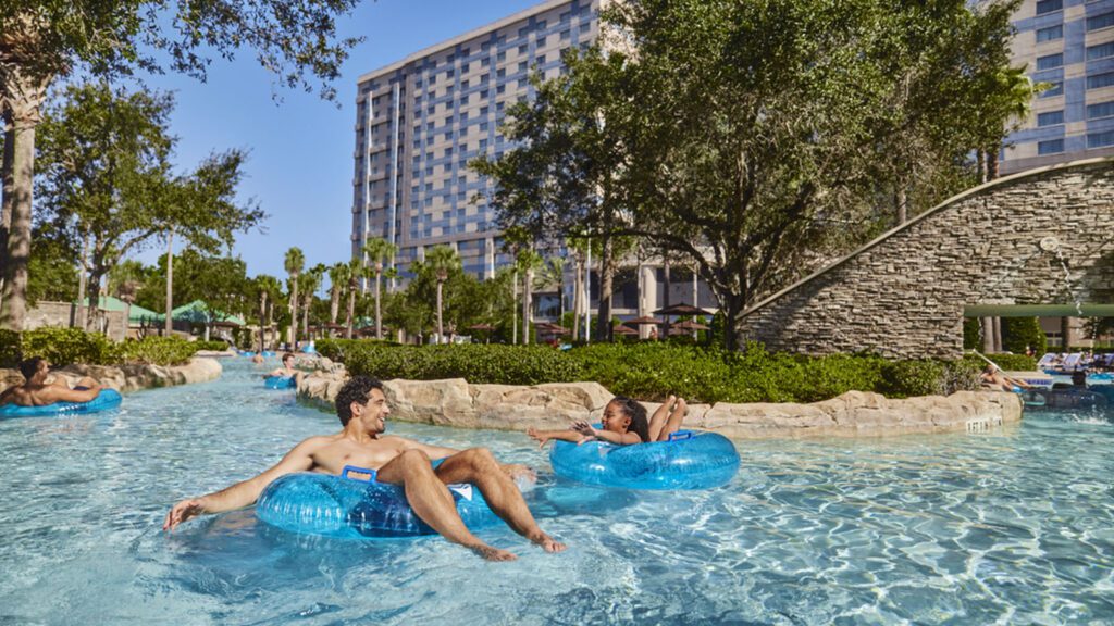 Father and daughter float along a lazy river