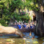 People waving from a water ride