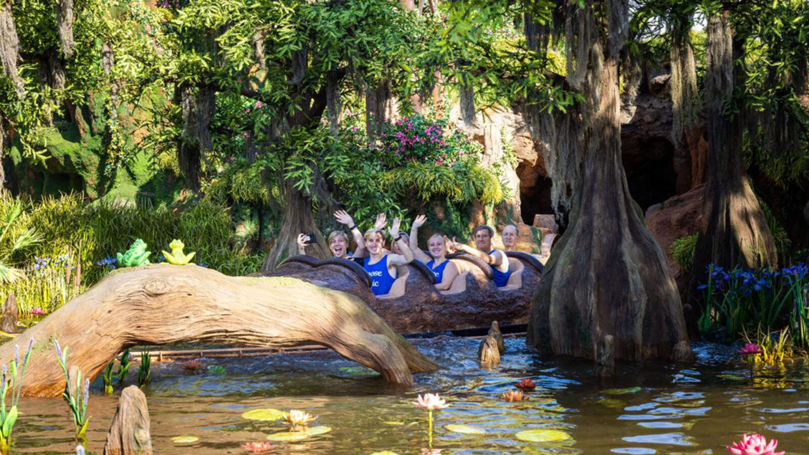 People waving from a water ride