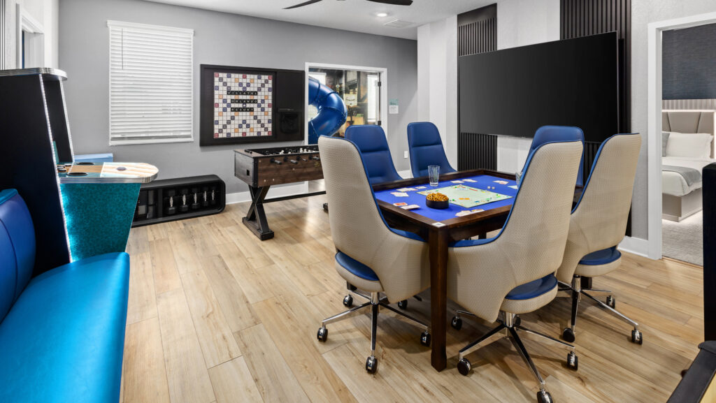 A games room with card table, video game unit, football and wall scrabble