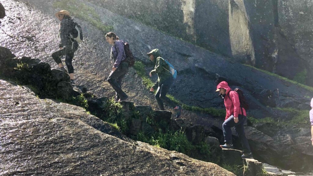 side view of people hiking up Yosemite's Mist Trail