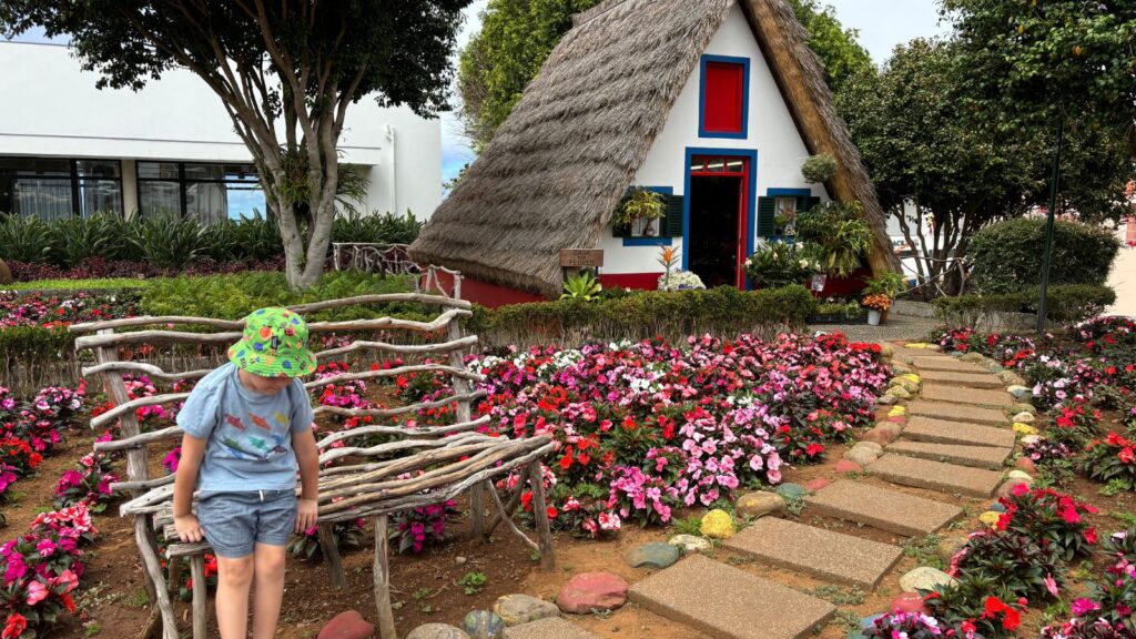 The municipality of Santana is a Biosphere reserve of UNESCO and colorful flowers appear against the iconic red, white and blue chalets.