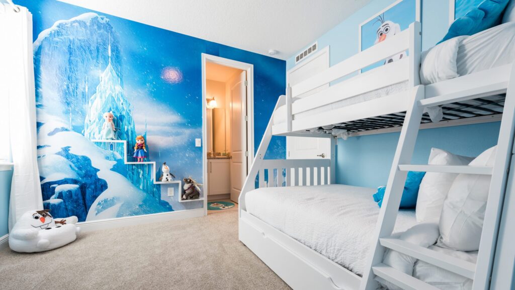 A Frozen-themed bedroom with white bunk beds and a snowman chair at Encore Resort at Reunion