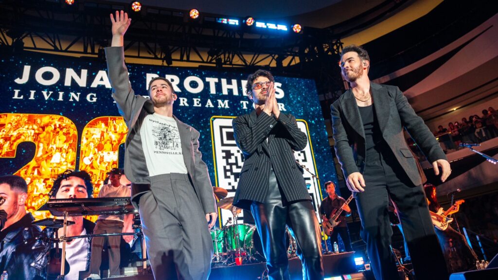 The Jonas Brothers waving to fans