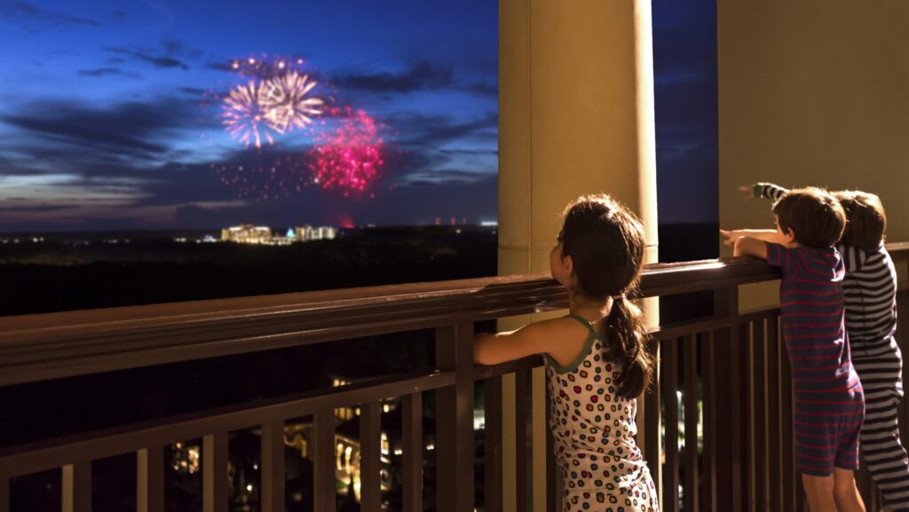 Three kids watching the fireworks in their pajamas at Four Seasons Resort Orlando