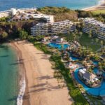An aerial view of the buildings, pools, and beach at Sheraton Maui Resort & Spa