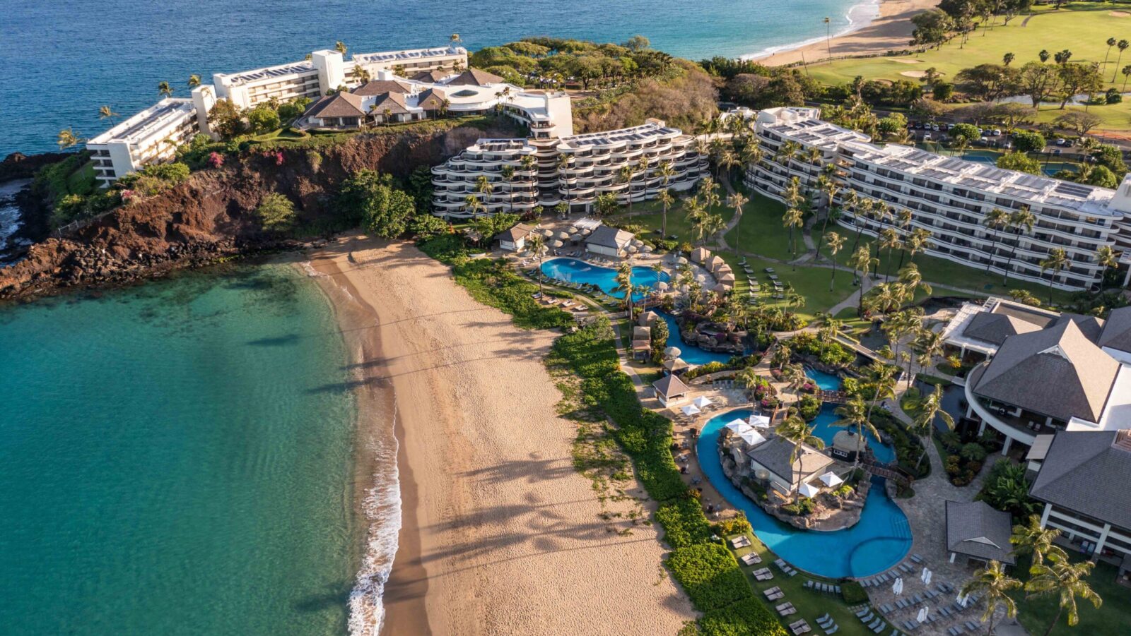 An aerial view of the buildings, pools, and beach at Sheraton Maui Resort & Spa