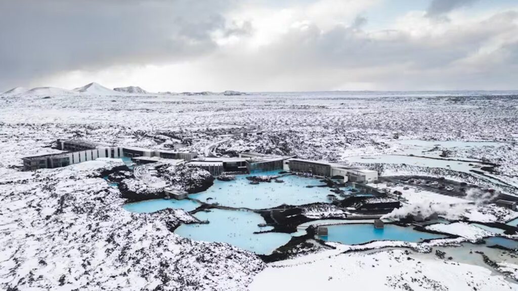 Blue Lagoon hot springs surrounded by snow-covered grounds and hills