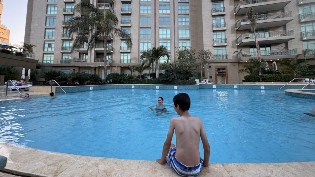 child sitting by the pool at the Four Seasons Cairo in Egypt