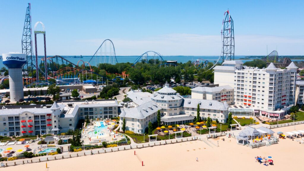 An aerial view of Hotel Breakers with the beach in front and Cedar Point amusement park behind it