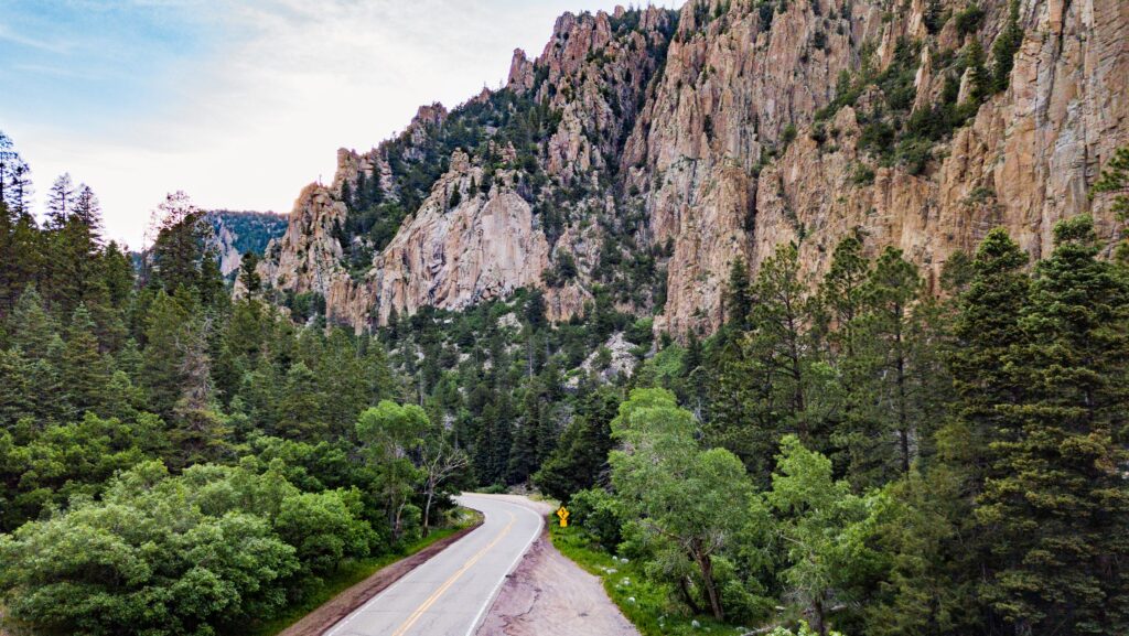 A road traveling through the rocky canyon at Cimarron Canyon State Park