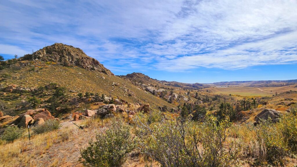 A mountain trails with sweeping views and blue skies overheard at Curt Gowdy State Park