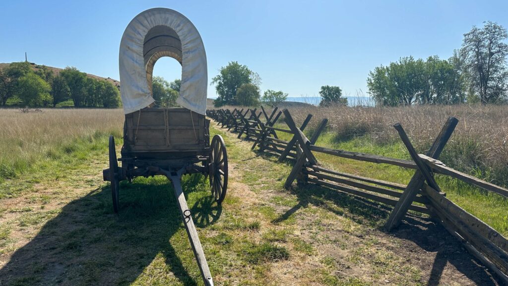 A replica covered wagon on a portion of the Oregon Trail at Whitman Mission in Walla Walla