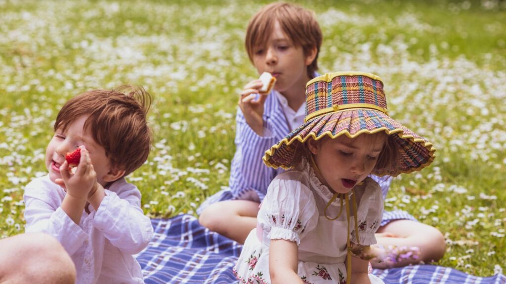 Children eating a picnic provided by The Athenaeum in London