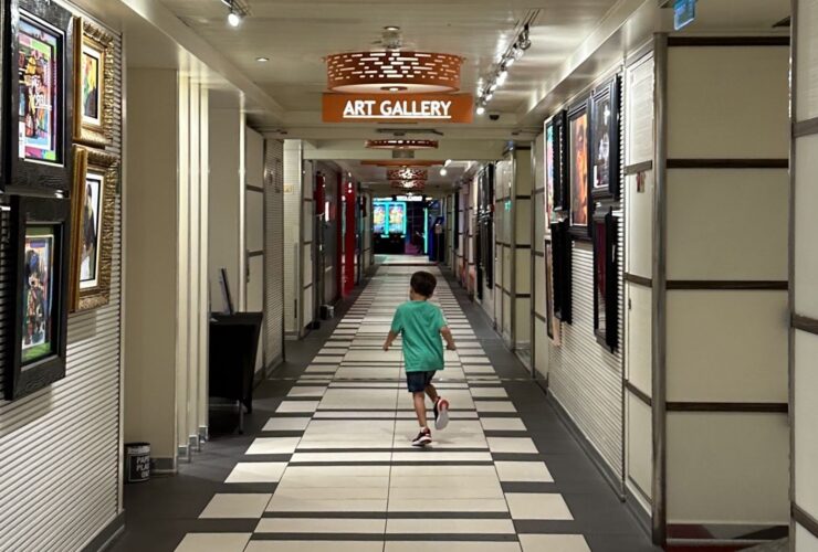 Child running down a hallway on a cruise ship
