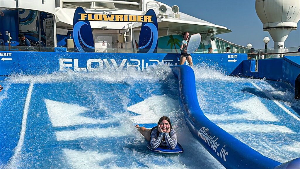 A teenage girl on the FlowRider on a Royal Caribbean cruise ship