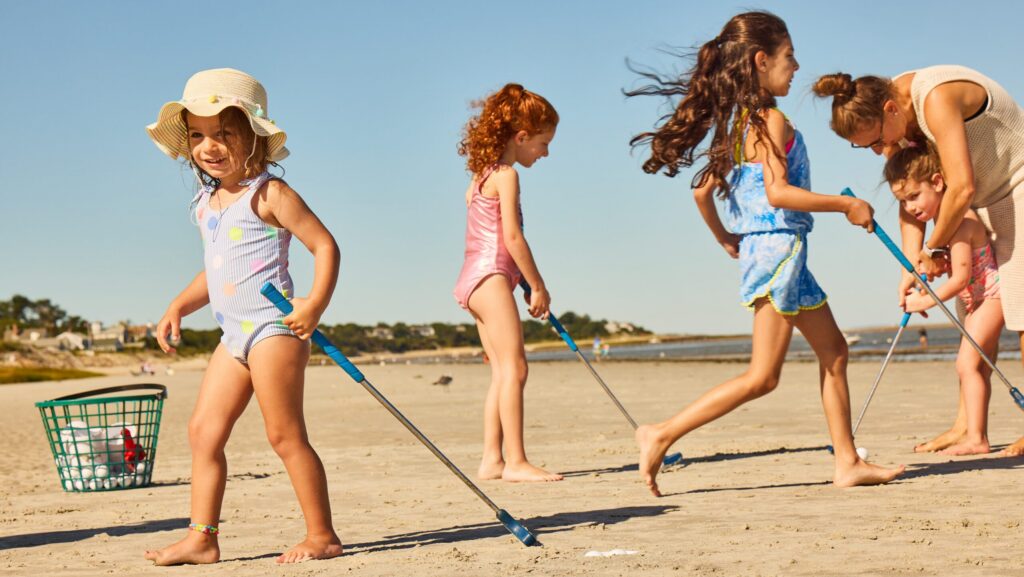 Kids and a mom playing low-tide mini golf at Ocean Edge Resort & Golf Club
