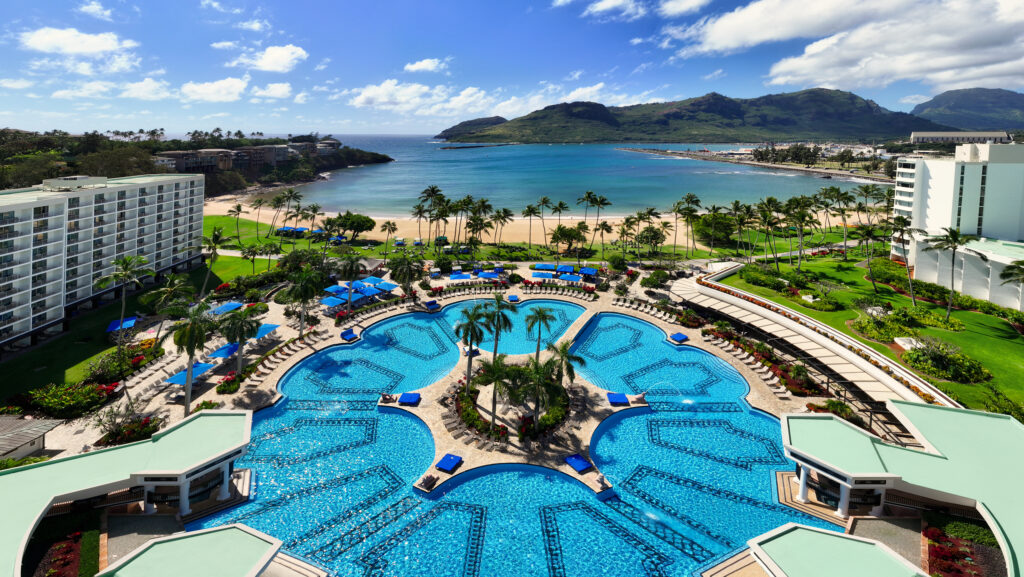 An aerial view of the large pool and beach area at The Royal Sonesta Kauaʻi Resort