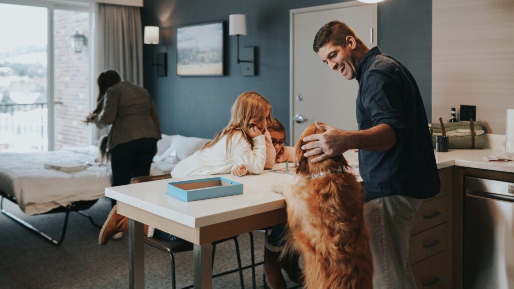 A family with their dog in one of the suites at The Wilson Hotel