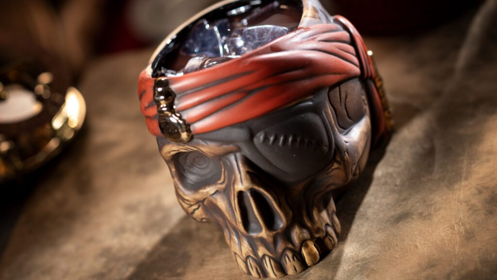 Skull-shaped cup holding a cocktail