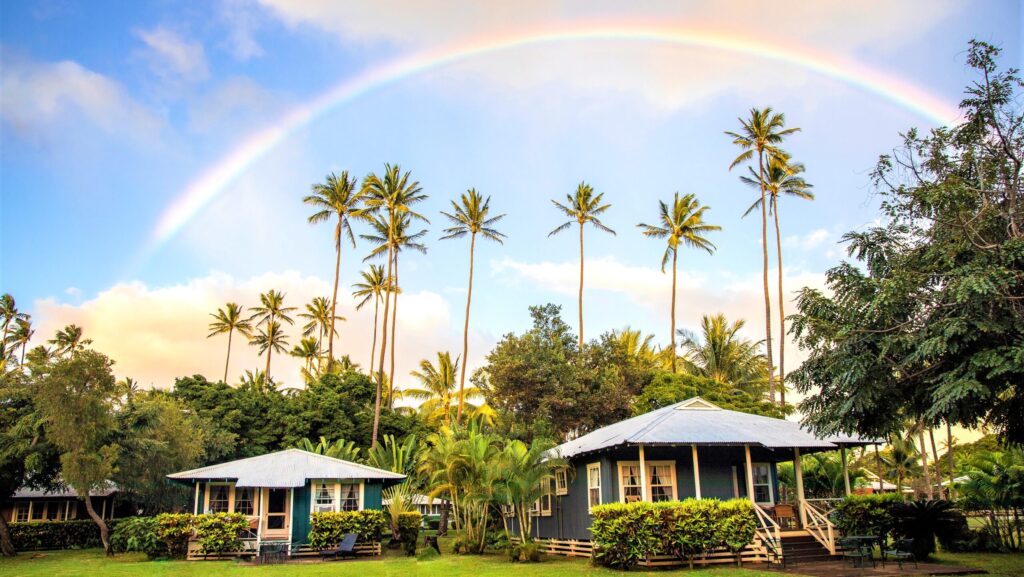 A rainbow arching over two of the cottages at Waimea Plantation Cottages
