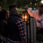 A man carrying a lantern leading a ghost tour in Gettysburg, PA