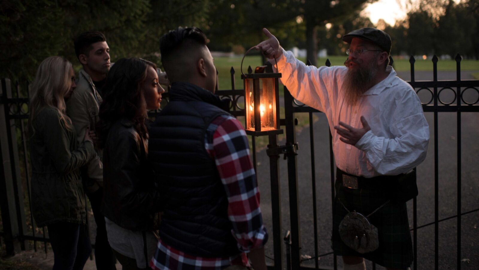 A man carrying a lantern leading a ghost tour in Gettysburg, PA