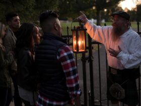 A man carrying a lantern leading a ghost tour in Gettysburg, PA