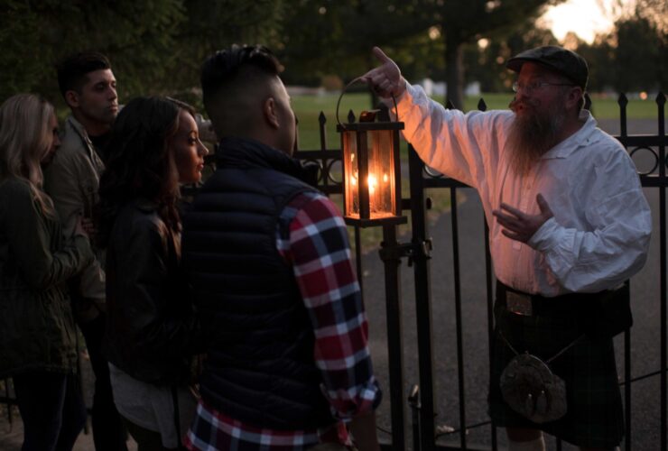 A man carrying a lantern leading a ghost tour in Gettysburg, PA