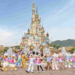 Hong Kong Disneyland's castle with characters in front of it.