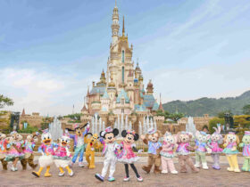 Hong Kong Disneyland's castle with characters in front of it.