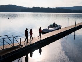 people walking along a dock toward a waiting boat at the Lodge at Schroon Lake during the quiet shoulder season