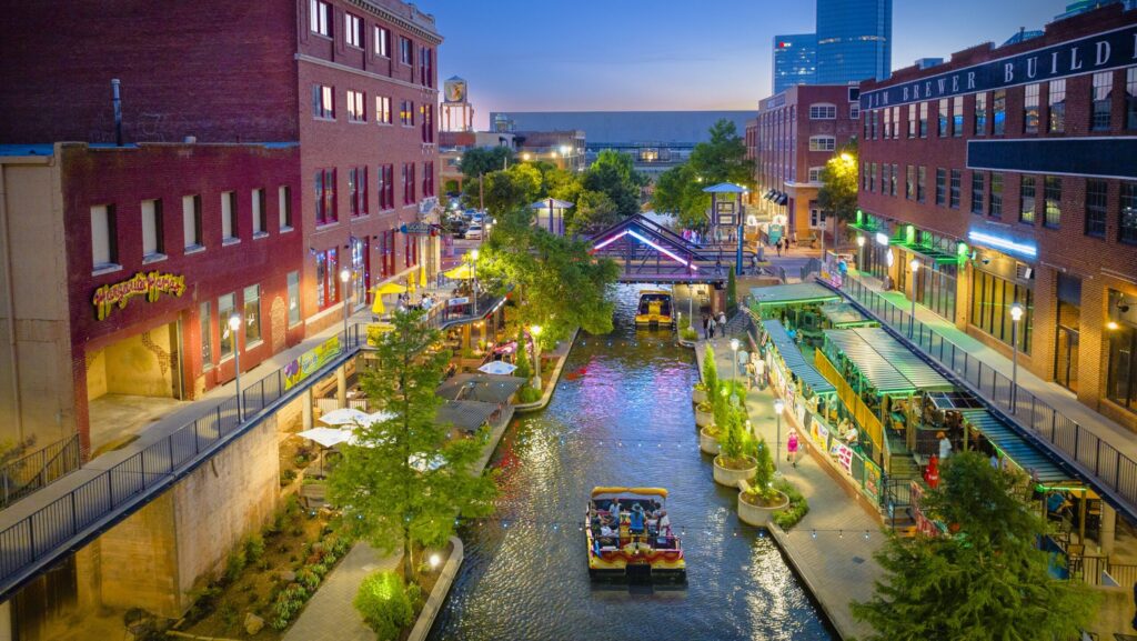 Boats traveling the Bricktown Canal at night in Oklahoma City