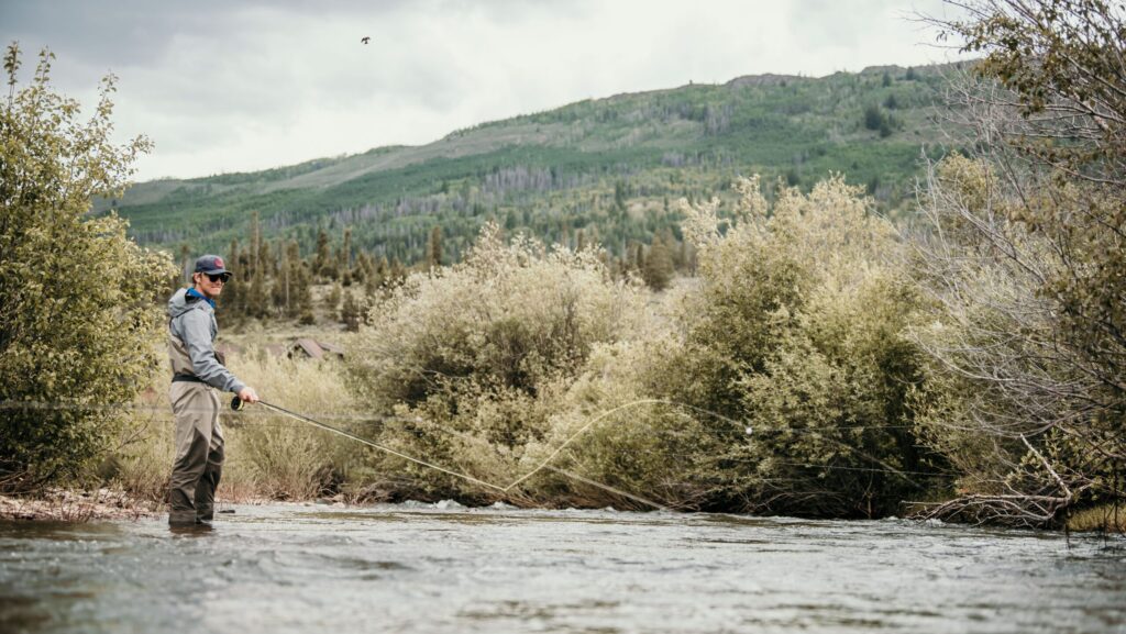 A man fly fishing at C Lazy U Ranch