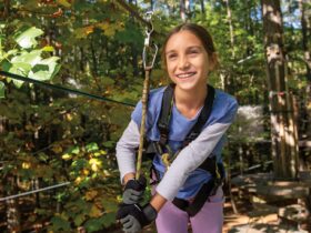 A girl ziplining in the woods in Williamsburg, VA