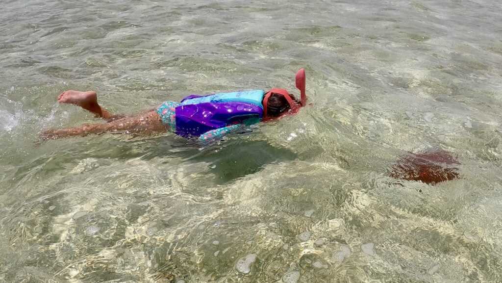 A girl snorkeling at Salterra Resort & Spa