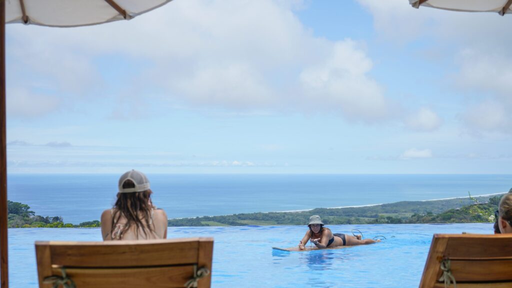 A surf coach teaching basics in a pool at Lamangata Luxury Surf Resort