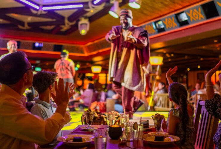 Family eating dinner on Disney Destiny