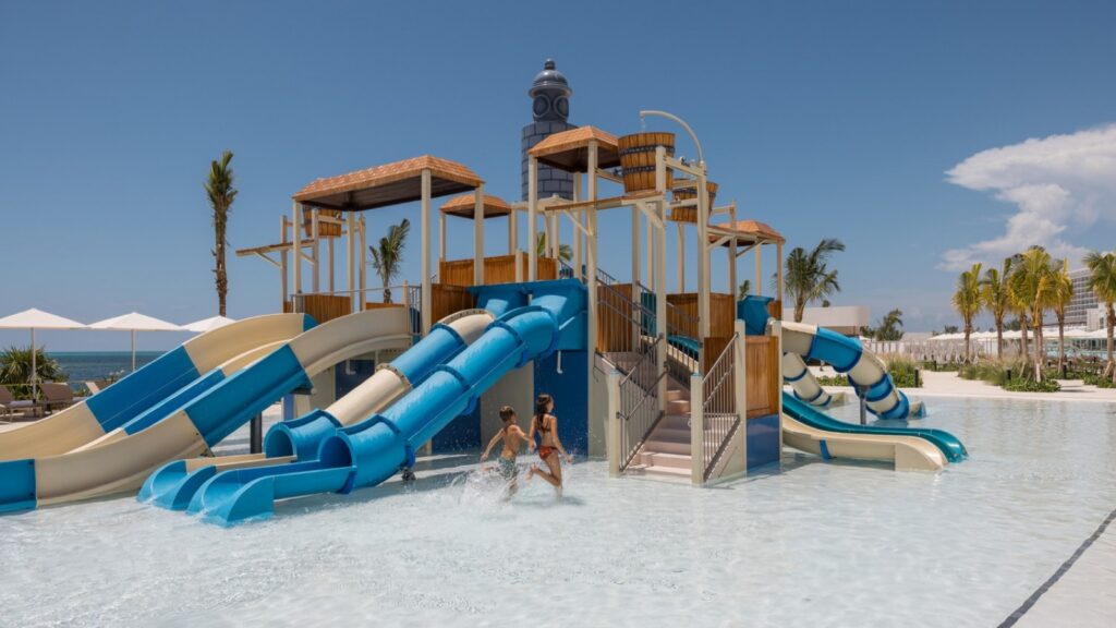 Two kids playing at the water park at AVA Cancun Resort