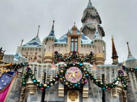 View of Disneyland castle decorated for holidays during its 70th anniversary