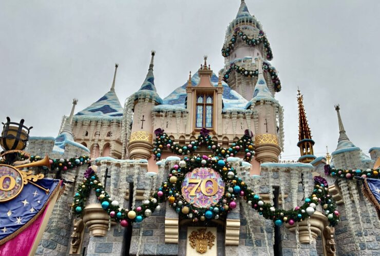 View of Disneyland castle decorated for holidays during its 70th anniversary