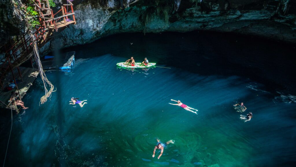 Travelers swimming in a cenote on an Intrepid Travel Short Break trip to Mexico