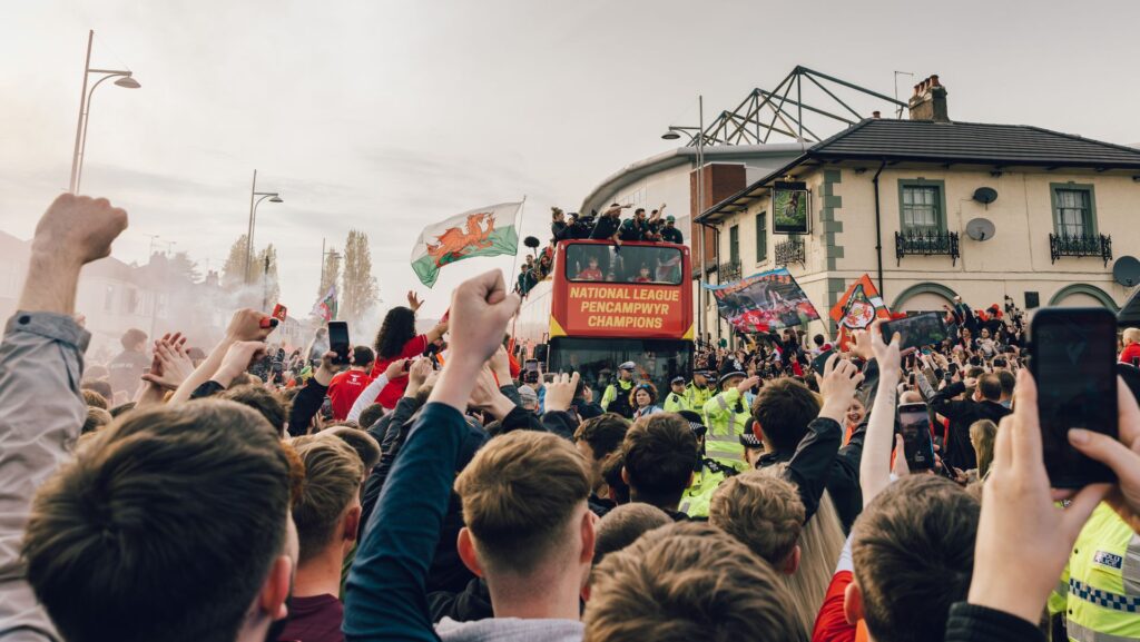 A crowd cheering on the Wrexham football team