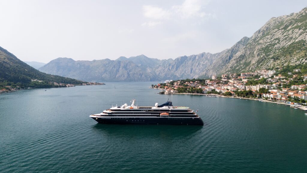 Atlas Ocean Voyages ship in a quiet cove.
