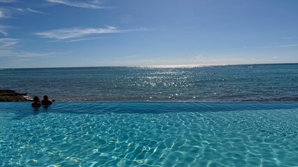 people lounging in an infinity pool at Club Med Punta Cana